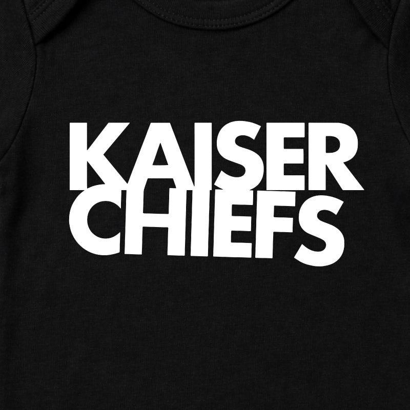 Close Up of Kaiser Chiefs Babygrow. Kaiser Chiefs logo printed in white on a plain black babygrow